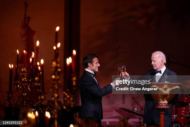 President Joe Biden and French President Emmanuel Macron share a toast after speaking at the state dinner on the South Lawn of the White House on...