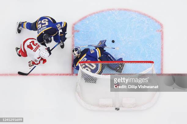 Colton Parayko and Jordan Binnington of the St. Louis Blues defend the goal against Seth Jarvis of the Carolina Hurricanes in the third period at...