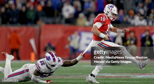 December 2: Boogie Basham of the Buffalo Bills grabs ahold of Mac Jones of the New England Patriots during the second half of the NFL game at...