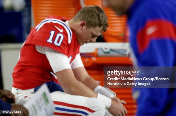 December 2: Mac Jones of the New England Patriots sits on the bench after losing 24-10 against the Buffalo Bills at Gillette Stadium on December 2,...