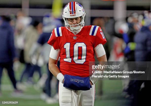 December 2: Mac Jones of the New England Patriots walks off the field after losing 24-10 against the Buffalo Bills at Gillette Stadium on December 2,...