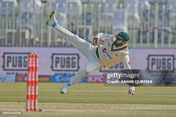 Pakistan's Azhar Ali throws the ball during the second day of the first cricket Test match between Pakistan and England at the Rawalpindi Cricket...