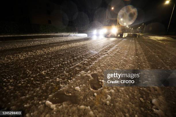 Road construction and maintenance center staff carry out a salt and de-icing operation on an urban bridge in Chenzhou city, Hunan Province, China,...