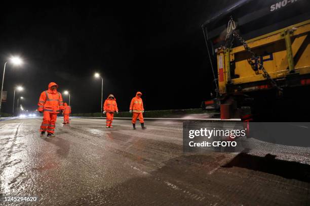 Road construction and maintenance center staff carry out a salt and de-icing operation on an urban bridge in Chenzhou city, Hunan Province, China,...