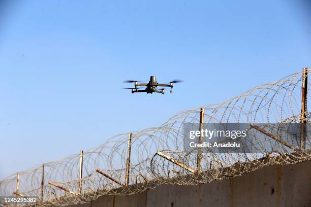 An unmanned air vehicle patrols the area as Turkish army members of 1st and 3rd Border Regiment Commands guard the border near Gaziantep, Turkiye on...