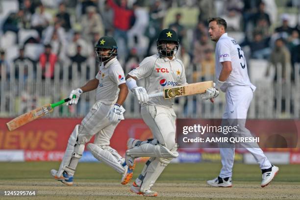 Pakistan's Imam-ul-Haq and teammate Abdullah Shafique run between the wicket during the second day of the first cricket Test match between Pakistan...