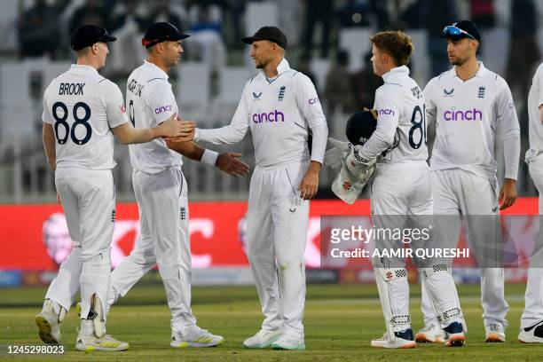 England's players shake hands at the end of the second day of the first cricket Test match between Pakistan and England at the Rawalpindi Cricket...