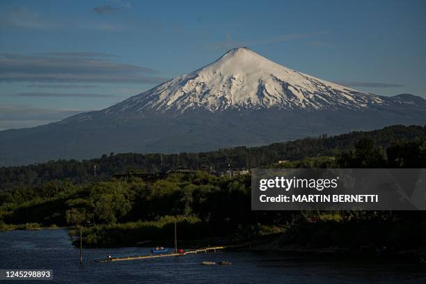 View of the Villarrica volcano, seen from Pucon, some 800 kilometers south of Santiago, taken on December 1, 2022. - Villarrica volcano is among the...