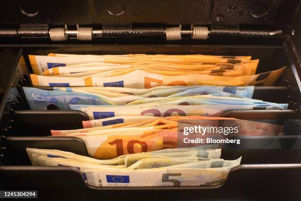 Euro banknotes in the till at a check out area inside a Mere discount supermarket, operated by Svetofor Group PAO, in Riga, Latvia, on Friday, Dec....