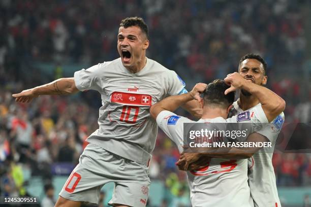 Switzerland's midfielder Xherdan Shaqiri celebrates with teammates after scoring his team's first goal during the Qatar 2022 World Cup Group G...