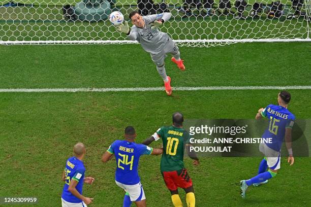 Brazil's goalkeeper Ederson saves a shot during the Qatar 2022 World Cup Group G football match between Cameroon and Brazil at the Lusail Stadium in...