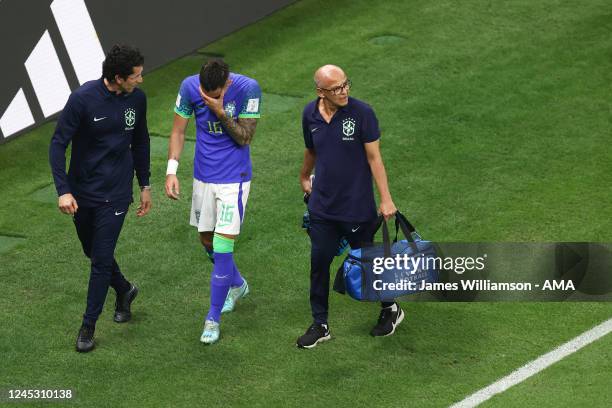 Alex Telles of Brazil leaves the field due to injury during the FIFA World Cup Qatar 2022 Group G match between Cameroon and Brazil at Lusail Stadium...