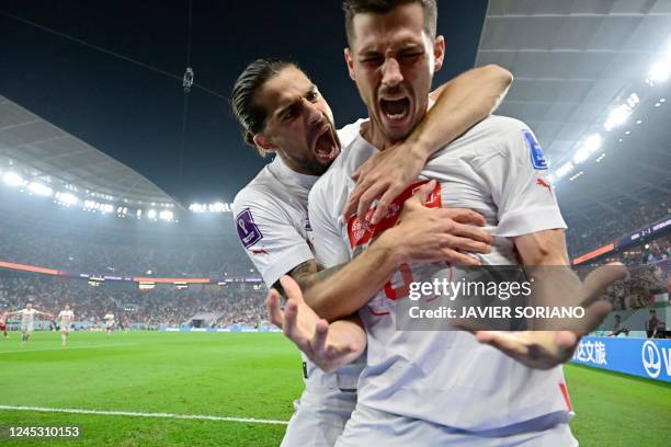 Switzerland's midfielder Remo Freuler celebrates with Switzerland's defender Ricardo Rodriguez after scoring his team's third goal during the Qatar...