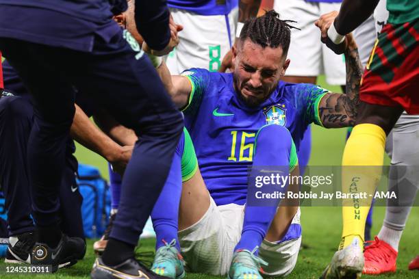 The injured Alex Telles of Brazil reacts and is substituted during the FIFA World Cup Qatar 2022 Group G match between Cameroon and Brazil at Lusail...