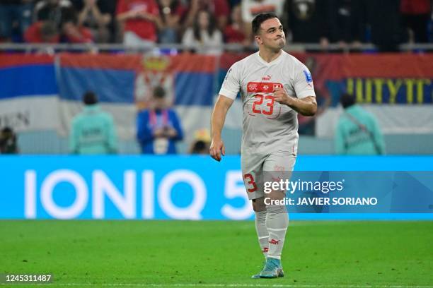 Switzerland's midfielder Xherdan Shaqiri celebrates scoring his team's first goal during the Qatar 2022 World Cup Group G football match between...