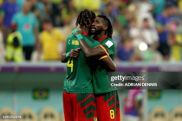 Cameroon's defender Christopher Wooh and Cameroon's midfielder Andre-Frank Zambo Anguissa celebrate at the end of the Qatar 2022 World Cup Group G...