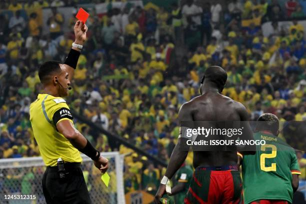 Referee Ismail Elfath shows a red card to Cameroon's forward Vincent Aboubakar after he takes his shirt off and earns a second yellow after scoring...