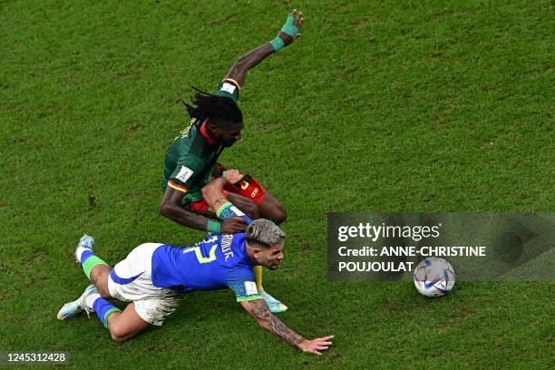 Brazil's midfielder Bruno Guimaraes fights for the ball with Cameroon's midfielder Andre-Frank Zambo Anguissa during the Qatar 2022 World Cup Group G...