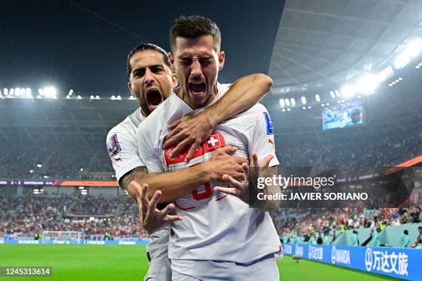 Switzerland's midfielder Remo Freuler celebrates with Switzerland's defender Ricardo Rodriguez after scoring his team's third goal during the Qatar...