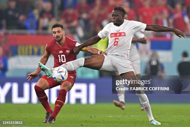 Serbia's forward Dusan Tadic fights for the ball with Switzerland's midfielder Denis Zakaria during the Qatar 2022 World Cup Group G football match...