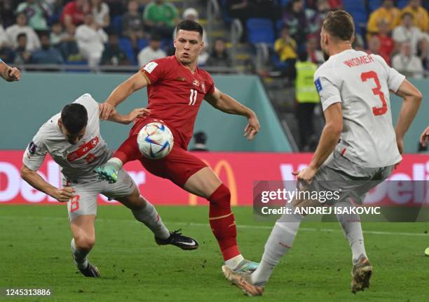 Serbia's forward Luka Jovic controls the ball past Switzerland's defender Silvan Widmer and Switzerland's midfielder Remo Freuler during the Qatar...