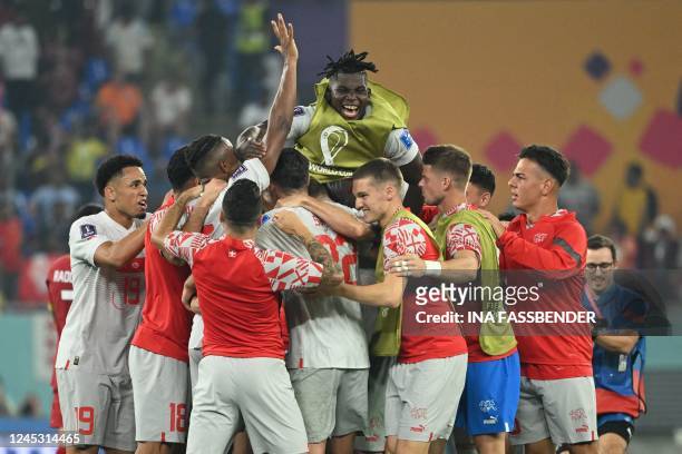 Switzerland's players celebrate their win in the Qatar 2022 World Cup Group G football match between Serbia and Switzerland at Stadium 974 in Doha on...