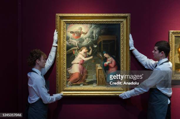 Art handlers hold a painting titled 'The Annunciation' by Lavinia Fontana estimate Â£40,000-60,000 during a photo call for the upcoming Classic Week...