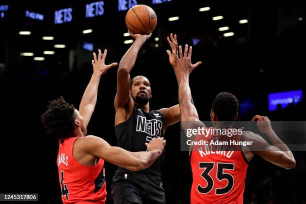 Kevin Durant of the Brooklyn Nets shoots over Christian Koloko of the Toronto Raptors during the first half at Barclays Center on December 2, 2022 in...