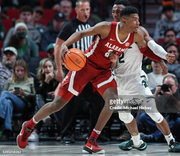 Brandon Miller of the Alabama Crimson Tide dribbles the ball against Tyson Walker of the Michigan State Spartans at Moda Center on November 24, 2022...