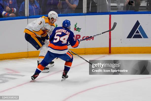 Nashville Predators Defenceman Jeremy Lauzon and New York Islanders Center Cole Bardreau chase the puck during the first period of the National...