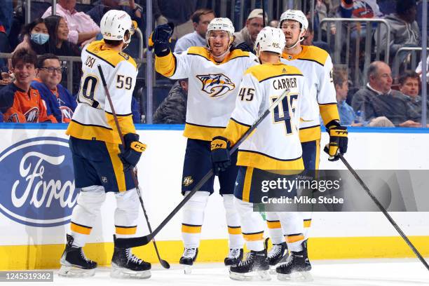 Matt Duchene of the Nashville Predators is congratulated by his teammates after scoring a goal against the New York Islanders during the third period...