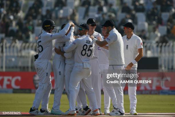 England's players celebrate after the dismissal of Pakistan's Imam-ul-Haq during the third day of the first cricket Test match between Pakistan and...