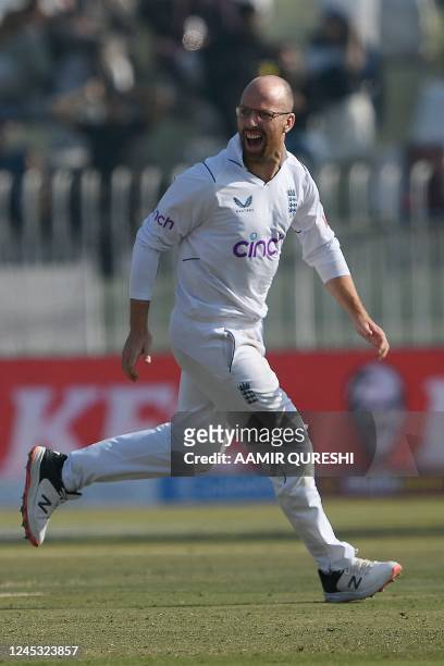 England's Jack Leach celebrates after taking the wicket of Pakistan's Imam-ul-Haq during the third day of the first cricket Test match between...