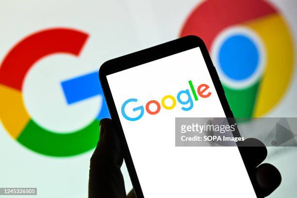 In this photo illustration a Google logo seen displayed on a smartphone.