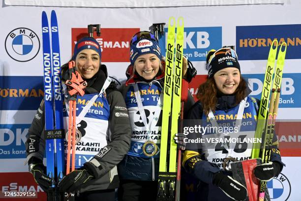 Second placed Italy's Lisa Vittozzi, winner Austria's Lisa Theresa Hauser and third placed Sweden's Linn Persson pose on the podium of the women's...