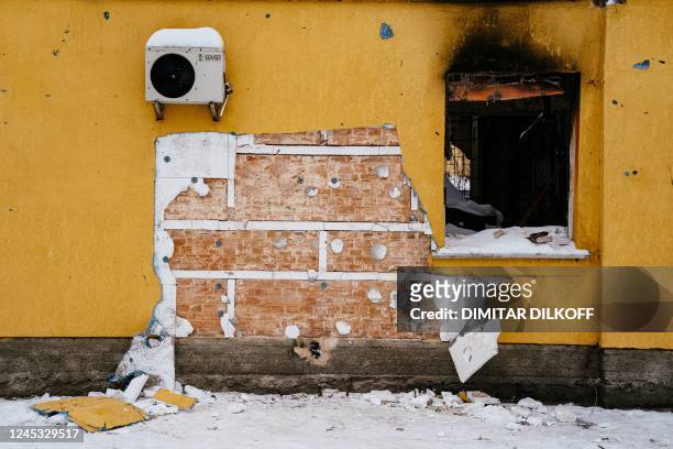 This photograph taken on December 3, 2022 shows a cut off of the wall of a damaged building from where a group people tried to steal a work of the...