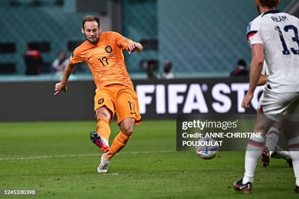 Netherlands' defender Daley Blind shoots to score his team's second goal during the Qatar 2022 World Cup round of 16 football match between the...