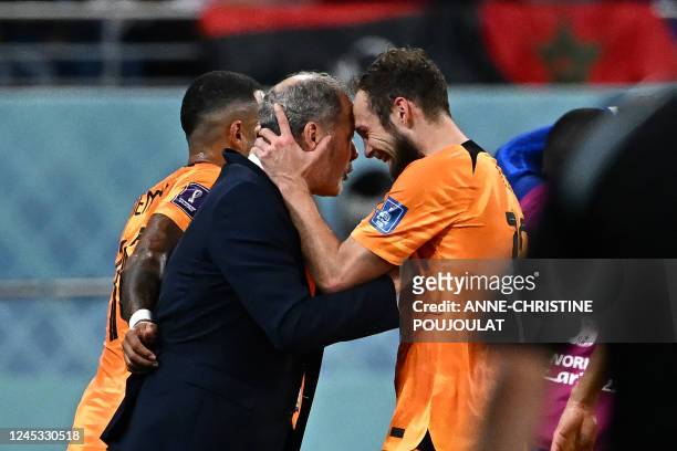 Netherlands' defender Daley Blind celebrates with his father, team assistant trainer Danny Blind after he scored his team's second goal during the...