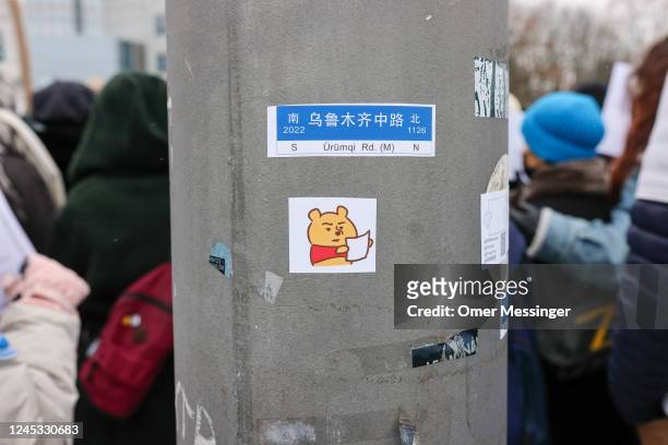 Sticker depicting Winnie-the-Pooh holding a blank paper was placed on a post as demonstrators protest in front of the Chinese Embassy in solidarity...