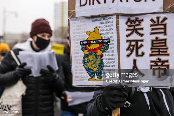 Demonstrator holds a banner depicting an image of Winnie-the-Pooh during a protest in front of the Chinese Embassy in solidarity with protesters in...