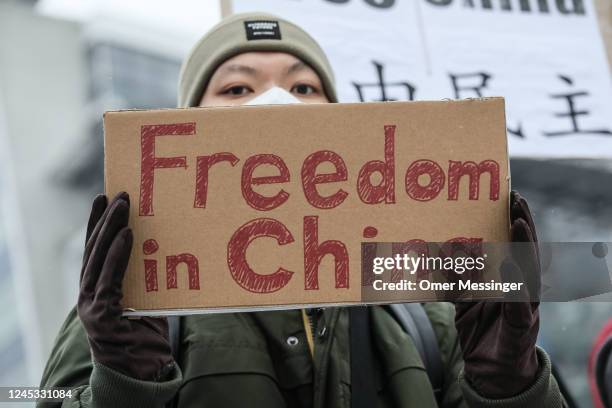 Participant holds a banner reading "Freedom in China" as demonstrators protest in front of the Chinese Embassy in solidarity with protesters in China...