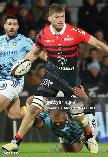 Toulouse's English flanker Jack Willis is tackled by Perpignan's Tongan tighthead prop Siua Halanukonuka during the French Top14 rugby union match...