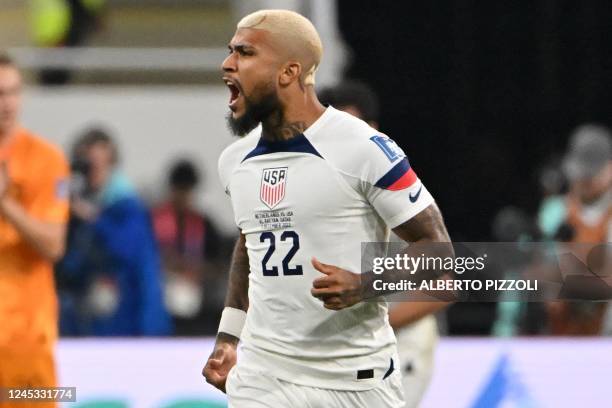 S defender DeAndre Yedlin celebrates after USA's forward Haji Wright scored his team's first goal during the Qatar 2022 World Cup round of 16...