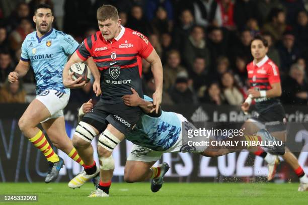 Toulouse's English flanker Jack Willis is tackled by Perpignan's Tongan tighthead prop Siua Halanukonuka during the French Top14 rugby union match...