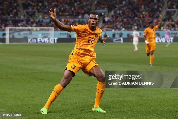Netherlands' defender Denzel Dumfries celebrates scoring his team's third goal during the Qatar 2022 World Cup round of 16 football match between the...