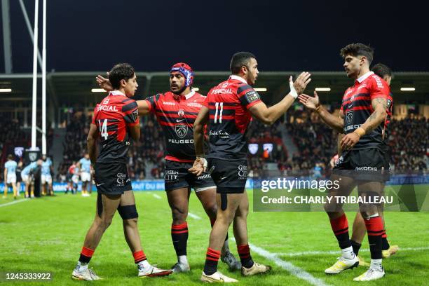 Toulouse's French full back Matthis Lebel celebrates with Toulouse's French fly-half Romain Ntamack after scoring a try during the French Top14 rugby...