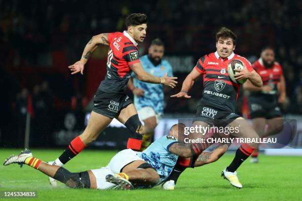 Toulouse's French scrum-half Antoine Dupont is tackled by Perpignan's Samoan flanker Piula Faasalele during the French Top14 rugby union match...