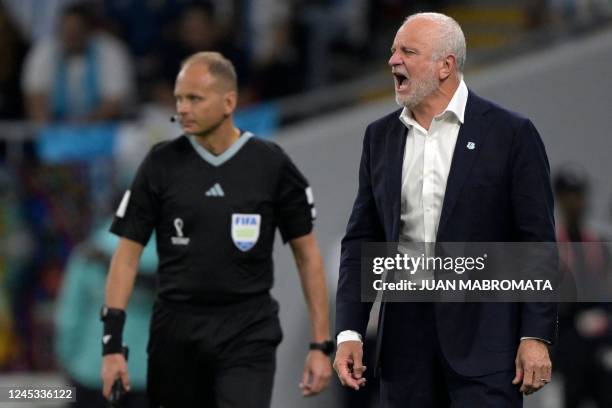 Australia's coach Graham Arnold shouts instructions to his players from the touchline during the Qatar 2022 World Cup round of 16 football match...