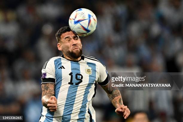 Argentina's defender Nicolas Otamendi heads the ball during the Qatar 2022 World Cup round of 16 football match between Argentina and Australia at...