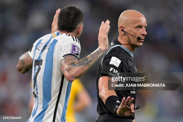 Argentina's midfielder Rodrigo De Paul argues with Polish referee Szymon Marciniak during the Qatar 2022 World Cup round of 16 football match between...